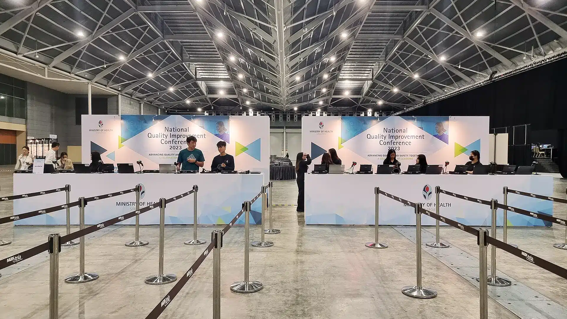 Staff member checking in an attendee at a counter