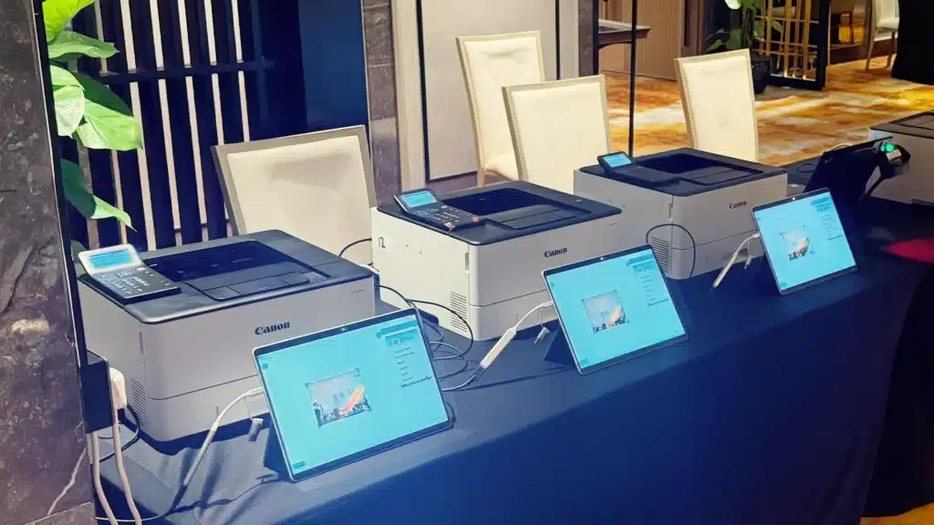 Klobbi badge printers and check-in tablets set up at a registration desk